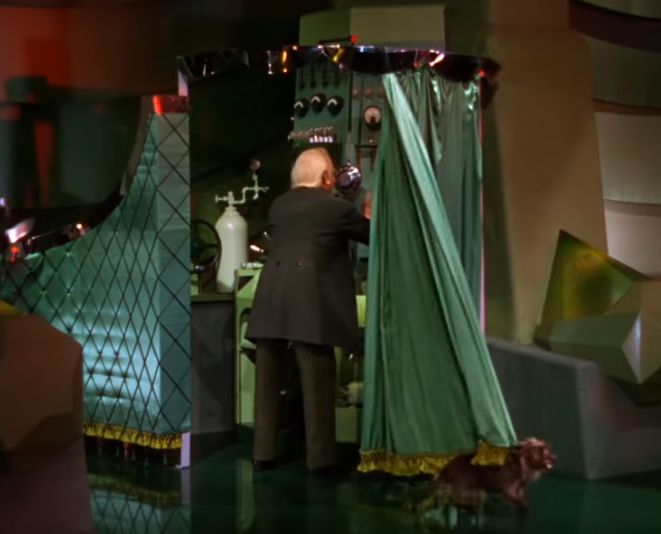 A Man in a Suit Stands Behind a Curtain A Man in a Suit Stands Behind a Curtain