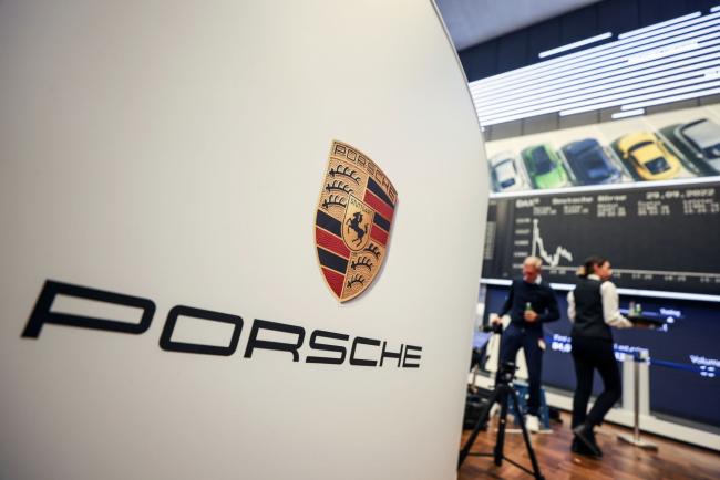 © Bloomberg. Signage for Porsche AG inside the Frankfurt Stock Exchange, operated by Deutsche Boerse AG, following the automaker's initial public offering (IPO) in Frankfurt, Germany, on Thursday, Sept. 29, 2022. The sports-car maker rose as much 2.9% to €84.90 after slipping to its offer price of €82.50 apiece, the top end of VW’s initial range for the shares that valued the company at €75 billion ($73 billion). Photographer Alex Kraus/Bloomberg