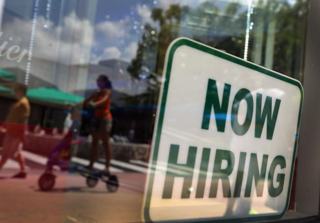© Bloomberg. MIAMI BEACH, FL - JULY 05: A ''Now Hiring'' sign is seen in the store front window on July 5, 2012 in Miami Beach, Florida. The ADP released the National Employment Report which showed that employment in the U.S. nonfarm private business sector increased by 176,000 from May to June on a seasonally adjusted basis.The government will release its closely watched employment report for June on Friday. (Photo by Joe Raedle/Getty Images)