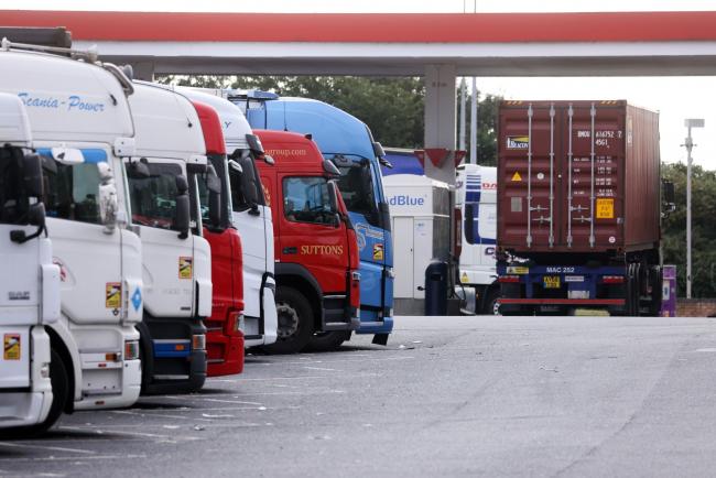 © Bloomberg. A row of trucks at a service station near Thurrock, U.K.