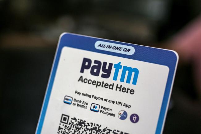 © Bloomberg. A restaurant advertises the use of the Paytm digital payment system in Mumbai, India, on Saturday, July 17, 2021. Paytm, the Indian digital payments pioneer backed by SoftBank Group Corp., is seeking approval for a $2.2 billion initial public offering that could be India's largest. Photographer: Dhiraj Singh/Bloomberg