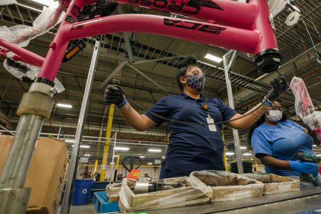 © Bloomberg. A Bicycle Corporation Of America employee prepares to install a chain on a bicycle at a Kent Bicycles production facility in Manning, South Carolina, U.S., on Thursday, May 13, 2021. Kent Bicycles is a New Jersey based bike producer that employs 225 workers and imports its parts from Asia.