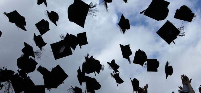 © Bloomberg. Students throw their mortarboards in the air during their graduation photograph at the University of Birmingham degree congregations on July 14, 2009 in Birmingham, England.