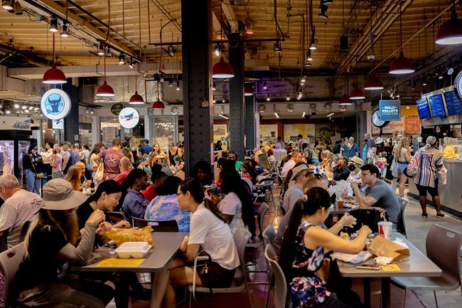 © Bloomberg. Customers dine indoors at Reading Terminal Market in Philadelphia, Pennsylvania, U.S., on Saturday, July 31, 2021. Philadelphia, as well as Montgomery and Delaware counties, are seeing 