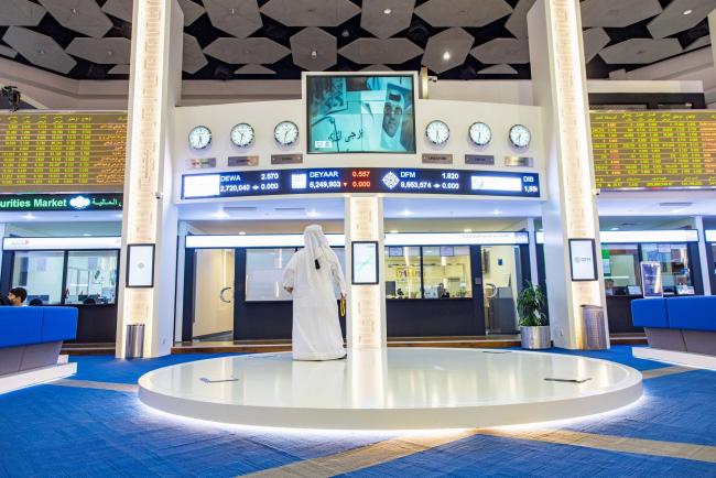 &copy Bloomberg. An investor looks up at a television news report at the Dubai Financial Market PJSC (DFM) in Dubai, United Arab Emirates, on Wednesday, Aug. 24, 2022. While not as intense as in other parts of the world, inflation is percolating in the oil-rich Gulf, with Dubai among countries in the region that have set aside billions of dollars in inflation relief. Photographer: Christopher Pike/Bloomberg