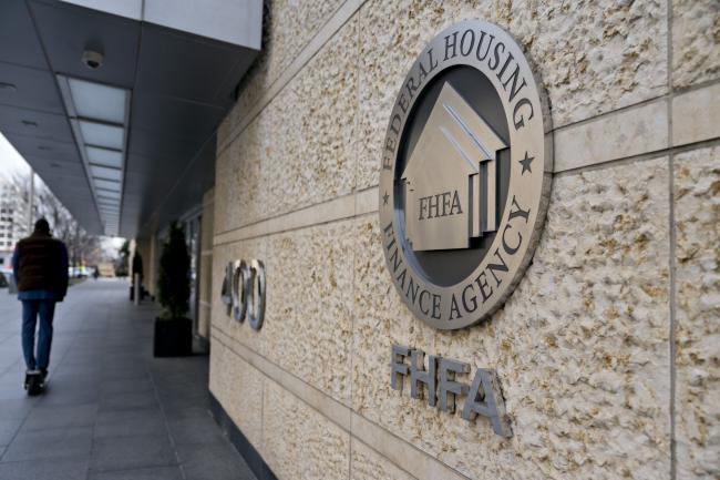 &copy Bloomberg. The seal of the Federal Housing Finance Agency (FHFA) is displayed outside the organization's headquarters in Washington, D.C., U.S., on Wednesday, March 20, 2019. President Donald Trump's pick to lead Fannie Mae and Freddie Macs regulator pledged to work with Congress on overhauling the companies, while downplaying controversial positions he's previously laid out on everything from the 30-year-mortgage to affordable housing initiatives.