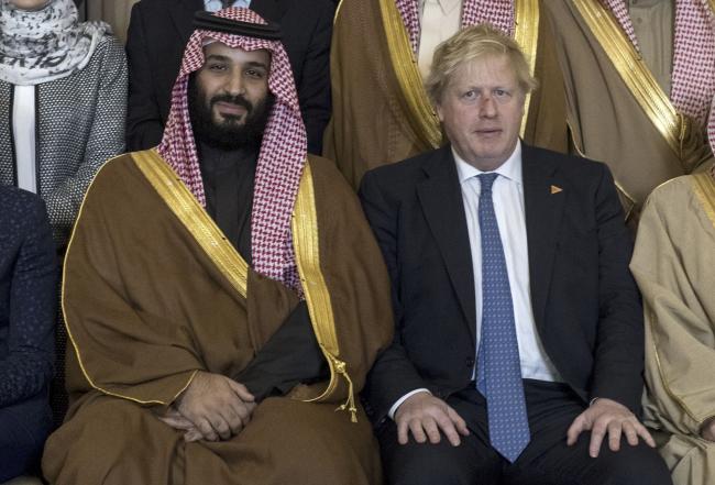 © Bloomberg. Mohammed bin Salman, Saudi Arabia's crown prince, center, and Boris Johnson sit for a photograph ahead of a meeting inside number 10 Downing Street in London, U.K., on Wednesday, March 7, 2018. emorandums of Understanding for 14 trade deals are due to be signed during the isit of the prince, but British officials don't expect a decision on who will ost the initial public offering of state oil company Aramco.