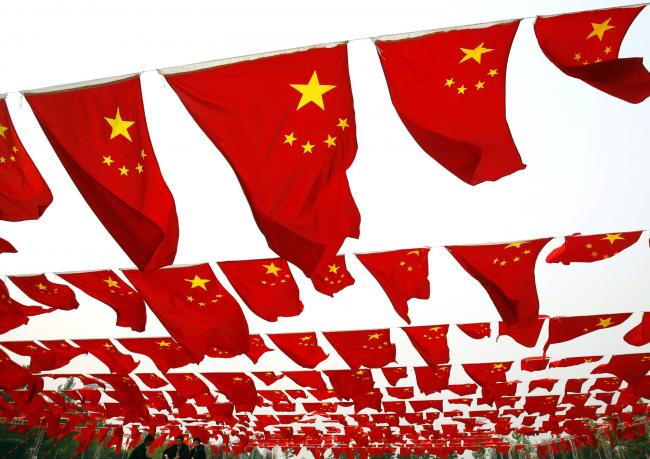 &copy Bloomberg. BEIJING, CHINA - SEPTEMBER 30: (CHINA OUT) Chinese people visit a national flag show at Chaoyang park September 30, 2006 in Beijing, China. Chinese people are preparing for National Day Celebration, the 57th anniversary of the founding of People's Republic of China which falls on October 1. (Photo by China Photos/Getty Images)