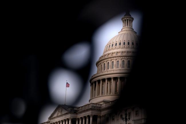 © Bloomberg. An American flag outside the U.S. Capitol building in Washington, D.C., U.S., on Tuesday, April 27, 2021. President Biden and House Democrats are clashing over how much to prioritize an extension of an expanded tax credit for parents. Photographer: Stefani Reynolds/Bloomberg