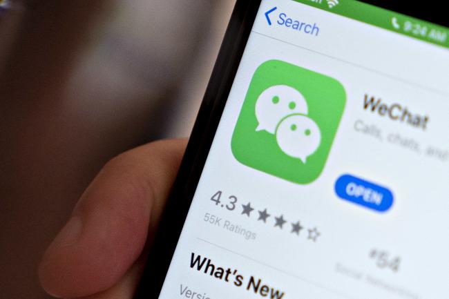 © Bloomberg. The Tencent Holdings Ltd. WeChat app is displayed in the App Store on a smartphone in an arranged photograph taken in Arlington, Virginia, U.S., on Friday, Aug. 7, 2020. President Donald Trump signed a pair of executive orders prohibiting U.S. residents from doing business with the Chinese-owned TikTok and WeChat apps beginning 45 days from now, citing the national security risk of leaving Americans' personal data exposed. Photographer: Andrew Harrer/Bloomberg