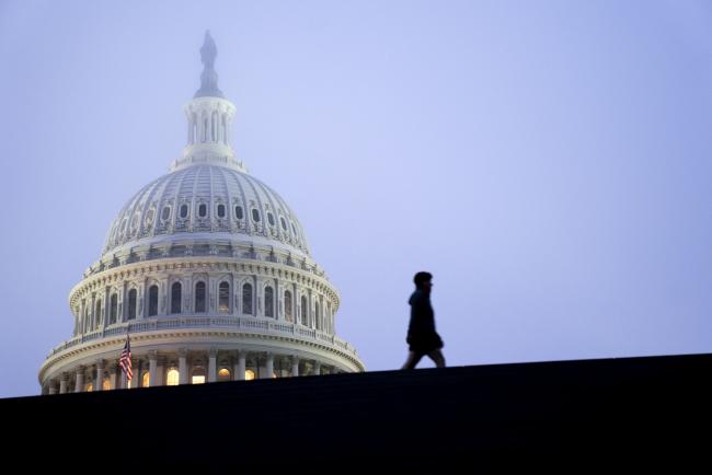 &copy Bloomberg. WASHINGTON, DC - OCTOBER 20: A pedestrian walks past the U.S. Capitol on October 20, 2020 in Washington, DC. Senate Republicans are looking to hold a confirmation vote for Supreme Court nominee Amy Coney Barrett on Monday, October 26, approximately one week before the Presidential election.(Photo by Stefani Reynolds/Getty Images) Photographer: Stefani Reynolds/Getty Images