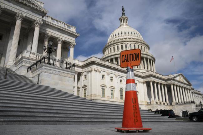 © Bloomberg. A caution sign outside the U.S. Capitol in Washington, D.C., U.S., on Tuesday, Sept. 21, 2021. House Democrats set up a Tuesday vote on a bill that would suspend the U.S. debt ceiling through December 2022 and temporarily fund the government to avert a shutdown at the end of this month. Photographer: Sarah Silbiger/Bloomberg