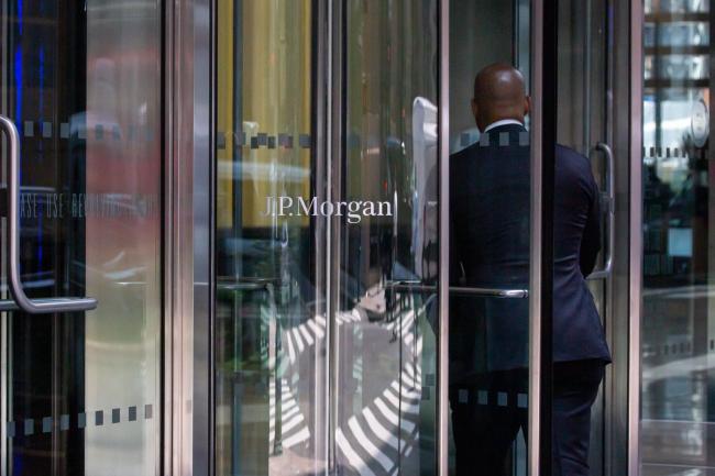 © Bloomberg. An office worker enters the JPMorgan Chase & Co. headquarters in New York, U.S., on Thursday, July 22, 2021. After a year of Zoom meetings and awkward virtual happy hours, New York's youngest aspiring financiers have returned to the offices of the city's investment banks, where they're making the most of the in-person mentoring and networking they've lacked during the pandemic. Photographer: Michael Nagle/Bloomberg