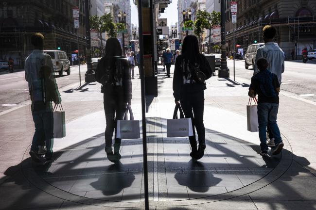 © Bloomberg. Pedestrians carry shopping bags on Geary street in San Francisco, California, US, on Wednesday, May 18, 2022. US retail sales grew at a solid pace in April, reflecting broad-based gains and suggesting demand for merchandise remains resilient despite rampant inflation. Photographer: David Paul Morris/Bloomberg