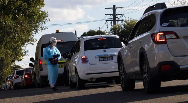 © Bloomberg. SYDNEY, AUSTRALIA - AUGUST 11: A long line of traffic is seen outside the Ashfield COVID-19 walk and drive-through testing clinic in Sydney's inner-west on August 11, 2021 in Sydney, Australia. New South Wales recorded 344 Covid-19 cases and two deaths in the last 24 hours, the second highest number of daily cases since the start of the pandemic. Greater Sydney is in lockdown through August 28th to contain the highly contagious Covid-19 delta variant (Photo by Brook Mitchell/Getty Images) Photographer: Brook Mitchell/Getty Images AsiaPac