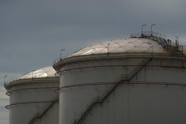 © Bloomberg. Fuel storage tanks at a PT Pertamina facility at Tanjung Priok Port in Jakarta, Indonesia, on Thursday, Feb. 24, 2022. Oil surged above $100 a barrel for the first time since 2014 as Russia attacked sites across Ukraine, triggering fears of a disruption to energy exports at a time of already tight supplies. Photographer: Dimas Ardian/Bloomberg