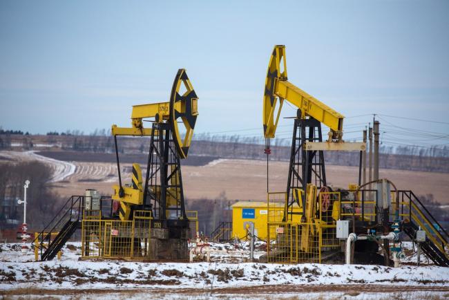 © Bloomberg. Oil pumping jacks, also known as 