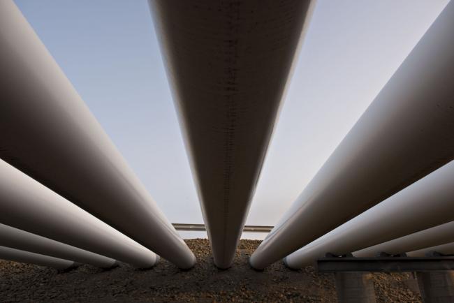 © Bloomberg. Oil pipes run into the ground at the Enbridge Inc. Cushing storage terminal in Cushing, Oklahoma, U.S., on Wednesday, March 25, 2015. Photographer: Daniel Acker/Bloomberg