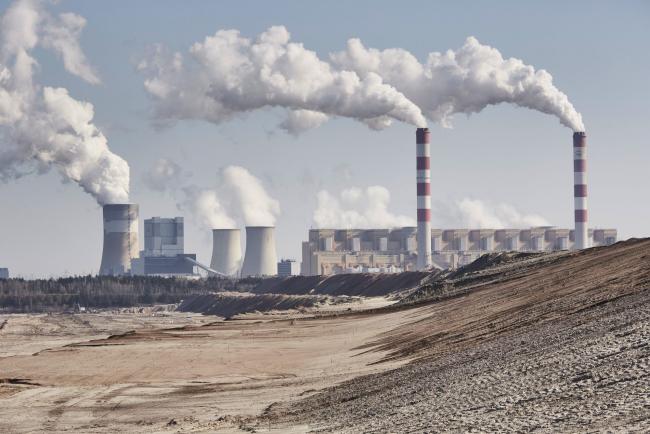 © Bloomberg. Excavated terrain at the open cast lignite mine, operated by PGE SA, near the Belchatow coal powered power plant, in Belchatow, Poland, on Wednesday, April 28, 2021. Poland’s plan to carve out coal-fired power plants, which would free up state-owned companies to invest in clean energy, sparked a rally in the country’s biggest utilities. Photographer: Bartek Sadowski/Bloomberg