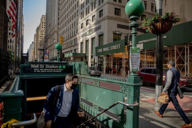 © Bloomberg. Commuters exits from the Wall Street subway station in New York, U.S., on Wednesday, May 12, 2021. With 37% of Manhattan fully vaccinated, the city's finance industry, slowly, is getting back into the office.