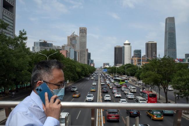 © Bloomberg. Vehicles travel along a road in Beijing, China, on Tuesday, June 7, 2022. As Beijing relaxes Covid curbs and allows indoor dining again, restaurants are betting that customers will be back in droves, boosting demand for everything from meat to cooking oils.