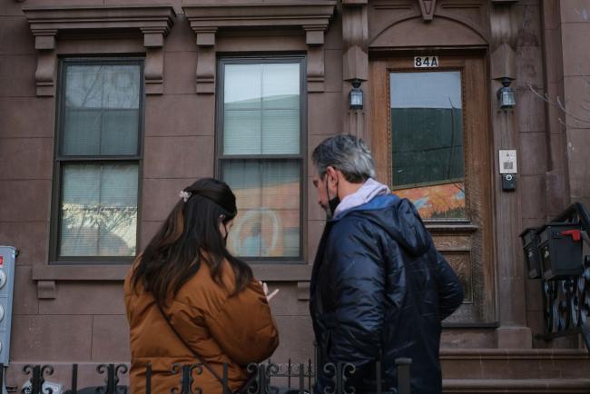 © Bloomberg. Prospective renters wait outside to enter an apartment unit during an open house in the Bedford-Stuyvesant neighborhood in the Brooklyn borough of New York, U.S., on Saturday, Feb. 12, 2022. Long lines in the cold, fierce competition and bidding wars. This has become the reality for New Yorkers who are flooding the rental market in search of apartments, an increasingly scarce commodity less than two years after a pandemic-related exodus had some predicting the demise of the city.