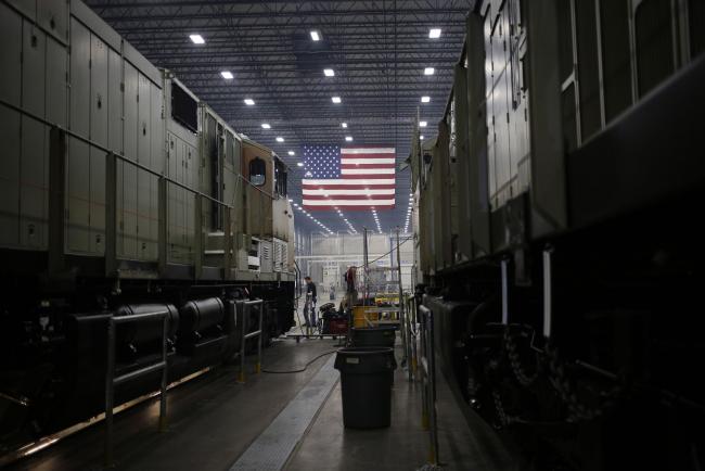 © Bloomberg. An American flag hangs at a factory in Fort Worth, Texas. Photographer: Luke Sharrett/Bloomberg