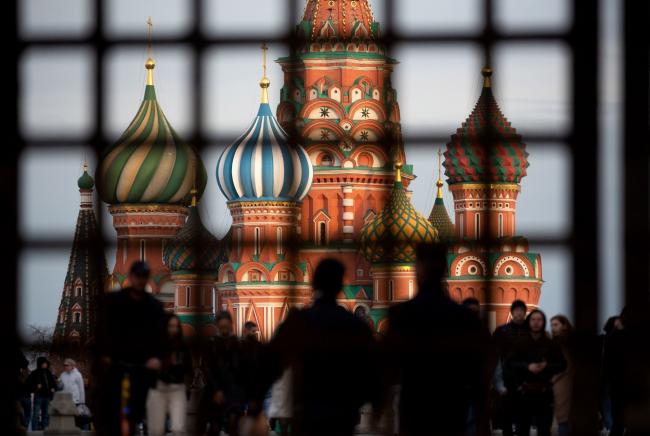 © Bloomberg. Pedestrians walk by Saint Basil's Cathedral on Red Square in Moscow, Russia, on Sunday, May 2, 2021. Facing a rising wave of Covid-19 infections and a vaccination rate that isn’t keeping up, the Kremlin is trying to contain the epidemic without alarming Russians.