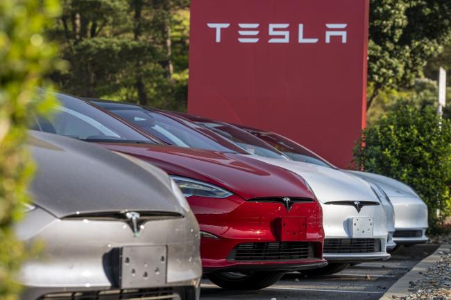 © Bloomberg. A Tesla dealership in Colma, California, U.S., on Wednesday, Jan. 26, 2022. U.S. auto sales will climb just 3.4% this year to 15.4 million cars and trucks as the semiconductor shortages continue to constrain vehicle inventory, auto dealers predict.