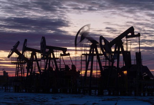 © Bloomberg. Oil pumping jacks, also known as 