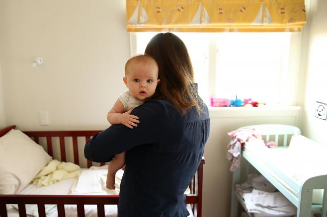 © Bloomberg. AUCKLAND, NEW ZEALAND - MAY 05: Secondary school teacher Sarah Ward at home on maternity leave with her three month old daughter Esme Kelliher, is in the last week of her paid parental leave allowance ahead of the New Zealand Federal Budget release, on May 5, 2015 in Auckland, New Zealand. New Zealand's Minister of Finance Bill English has announced that Budget 2015 will be presented on May 21, 2015. (Photo by Fiona Goodall/Getty Images)