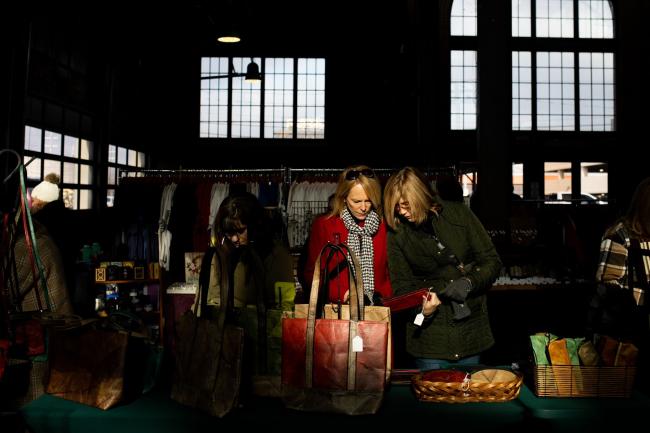 &copy Bloomberg. Shoppers at a holiday market in Eastern Market in Detroit, Michigan, US, on Sunday, Dec. 11, 2022. US consumer confidence fell in November to a four-month low amid the double blow of persistent inflation and rising interest rates. Photographer: Emily Elconin/Bloomberg