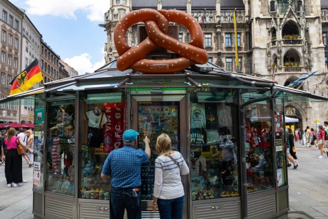 &copy Bloomberg. Customers look at Germany and Munich themed stickers, badges and other mementos at a souvenir kiosk in Munich, Germany, on Saturday, June 11, 2022. Confidence in the German economy improved a little, while remaining depressed, as fewer investors predict the outlook will deteriorate further in the face of record inflation and the war in Ukraine.