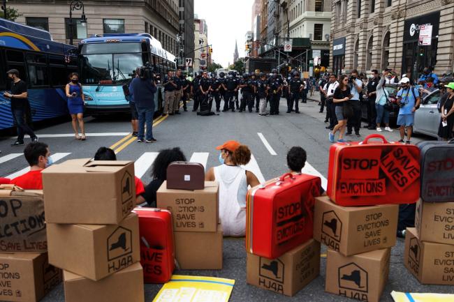 © Bloomberg. Demonstrators block a street to traffic during an 'Eviction Moratorium Extension' rally in the Brooklyn borough of New York on Aug. 19.