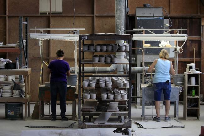 © Bloomberg. Workers manufacture dinnerware at the Fiesta Tableware Co. factory in Newell, West Virginia, U.S., on Thursday, July 22, 2021. Markit is scheduled to release manufacturing figures on August 2. Photographer: Luke Sharrett/Bloomberg