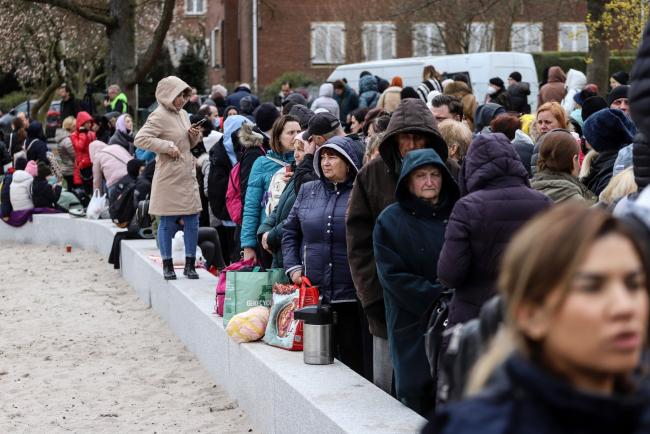 © Bloomberg. Displaced Ukrainians wait outside an immigration office in Brussels, Belgium, on Monday, March 14, 2022. At least 2.5 million Ukrainians are estimated to have fled their country in the wake of Russia's invasion, with Poland taking the bulk of the influx.