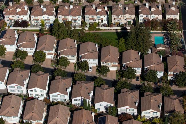 © Bloomberg. Houses stand in this aerial photograph taken near Cupertino, California, U.S., on Wednesday, Oct. 23, 2019. Facebook Inc. is following other tech titans like Microsoft Corp. and Google, pledging to use its deep pockets to ease the affordable housing shortage in West Coast cities. The social media giant said that it would commit $1 billion over the next decade to address the crisis in the San Francisco Bay Area.