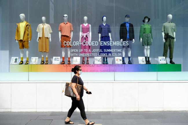 © Bloomberg. A pedestrian passes an Uniqlo Co. store in Kuala Lumpur, Malaysia, on Saturday, June 11, 2022. The Malaysian economy gained speed in the first quarter of this year, as the country dropped most virus restrictions. That allowed the central bank room to raise borrowing costs this month to preemptively fight inflation, even though consumer prices are gaining at the slowest rate in Southeast Asia.