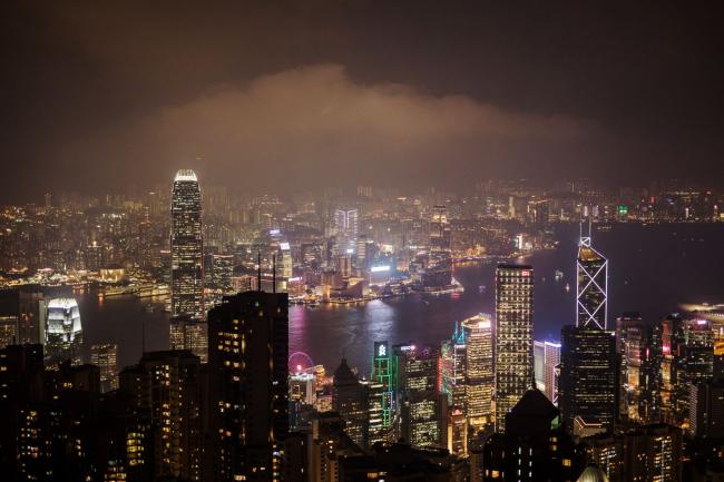 © Bloomberg. Buildings on the Hong Kong skyline are seen from Victoria Peak at night in Hong Kong, China, on Wednesday, Aug. 28, 2019. Anti-government protesters in Hong Kong have sustained their momentum since the first rally on June 9, creating the biggest crisis for Beijings rule over the former British colony since returning to China in 1997. On Monday, Sept. 16, the protests, which show no sign of stopping, will reach the 100-day mark. Photographer: Bloomberg/Bloomberg