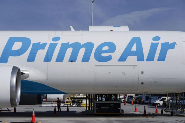 © Bloomberg. An Amazon Prime Air aircraft at the company's Air Hub at the Cincinnati/Northern Kentucky International Airport (CVG) in Hebron, Kentucky, U.S., on Monday, Oct. 11, 2021. Tech shares outperformed after a report showing a faster-than-expected increase in consumer prices last month lifted companies best able to handle those price pressures. Giants Microsoft Corp. and Amazon.com Inc. led gains in the tech-heavy Nasdaq 100, Photographer: Jeffrey Dean/Bloomberg