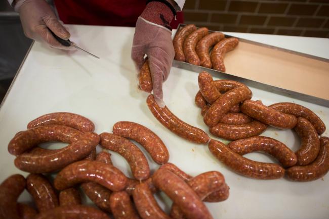 © Bloomberg. An employee separates sausage links and places them onto a tray for display at the meat department of a Whole Foods Market Inc. store in Dublin, Ohio, U.S., on Friday, Nov. 7, 2014. Whole Foods Market Inc. posted fiscal fourth-quarter profit that topped analysts' estimates as the grocery-store chain slashed prices to win over bargain-hunting shoppers. The shares soared the most in four years. Photographer: Ty Wright/Bloomberg