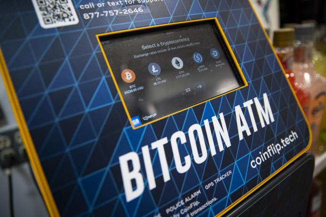 &copy Bloomberg. Cryptocurrencies listed on a Bitcoin automated teller machine (ATM) at a liquor store in Washington, DC, US, on Thursday, Jan. 19, 2023. Bitcoin steadied after snapping a rare 14-day winning streak as a mood of caution supplanted the risk appetite that drove up a variety of assets at the start of the year.