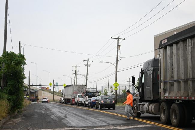 &copy Bloomberg. PHILADELPHIA, PENNSYLVANIA - JUNE 12: A man exits his truck and observes traffic as a result of a bridge collapse on Interstate 95 after an oil tanker explosion on June 12, 2023 in Philadelphia, Pennsylvania. With the closure of this primary north-to-south highway for East Coast travel, the morning commute was severely effected. (Photo by Mark Makela/Getty Images)