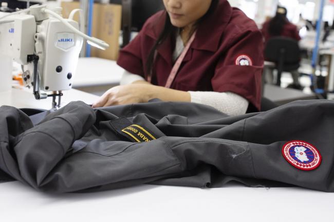 &copy Bloomberg. An employee sews a zipper onto a jacket at the new Canada Goose Inc. manufacturing facility in Montreal, Quebec, Canada, on Monday, April 29, 2019. The facility is Canada Goose's second factory in Quebec and eighth wholly-owned facility in Canada.