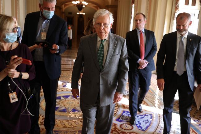 © Bloomberg. WASHINGTON, DC - NOVEMBER 18: Senate Minority Leader Mitch McConnell (R-KY) and members of his staff walk to a meeting with Senate Majority Leader Charles Schumer's office in the U.S. Capitol on November 18, 2021 in Washington, DC. McConnell and Schumer are meeting to discuss the upcoming debt ceiling following the release of a Treasury Department letter saying the new deadline for default is Dec. 15. (Photo by Chip Somodevilla/Getty Images)