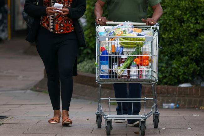 © Bloomberg. A customer pushes a shopping trolley full of groceries at an Aldi Stores Ltd. supermarket in London, UK, on Friday, June 24, 2022. The Office for National Statistics said Friday the volume of goods sold in stores and online fell 0.5% in May, as soaring food prices forced consumers to cut back on spending in supermarkets.