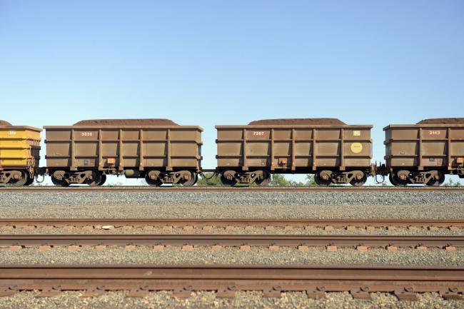 &copy Bloomberg. A freight train carrying iron ore travels along a track near a Rio Tinto Group rail yard in Karratha, Western Australia, Australia, on Wednesday, June 22, 2022. Iron ore is on course to end the week lower, with the increase in Chinese steel plants being idled and swelling inventories seen as signs of stagnant demand. Photographer: Carla Gottgens/Bloomberg