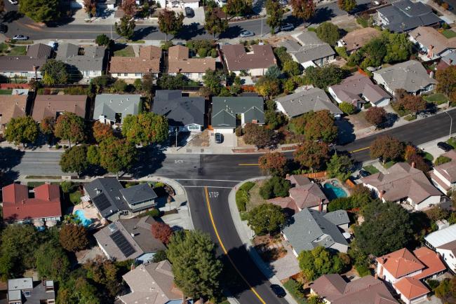 © Bloomberg. Houses stand in this aerial photograph taken near Cupertino, California, U.S., on Wednesday, Oct. 23, 2019. Facebook Inc. is following other tech titans like Microsoft Corp. and Google, pledging to use its deep pockets to ease the affordable housing shortage in West Coast cities. The social media giant said that it would commit $1 billion over the next decade to address the crisis in the San Francisco Bay Area.