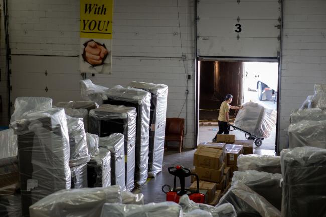 © Bloomberg. A worker moves furniture to a delivery truck at a furniture manufacturing facility in Hiddenite, North Carolina. Photographer: Logan Cyrus/Bloomberg