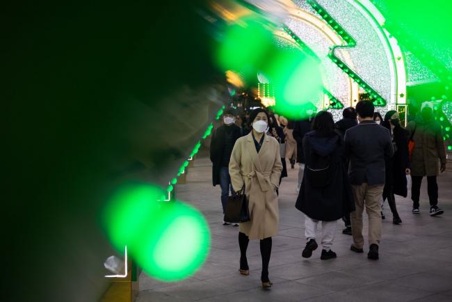 © Bloomberg. Visitors walk through illuminated festival installations at night in Seoul, South Korea, on Monday, Nov. 29, 2021. South Korea is scheduled to release gross domestic product (GDP) figures on Dec. 2. Photographer: SeongJoon Cho/Bloomberg